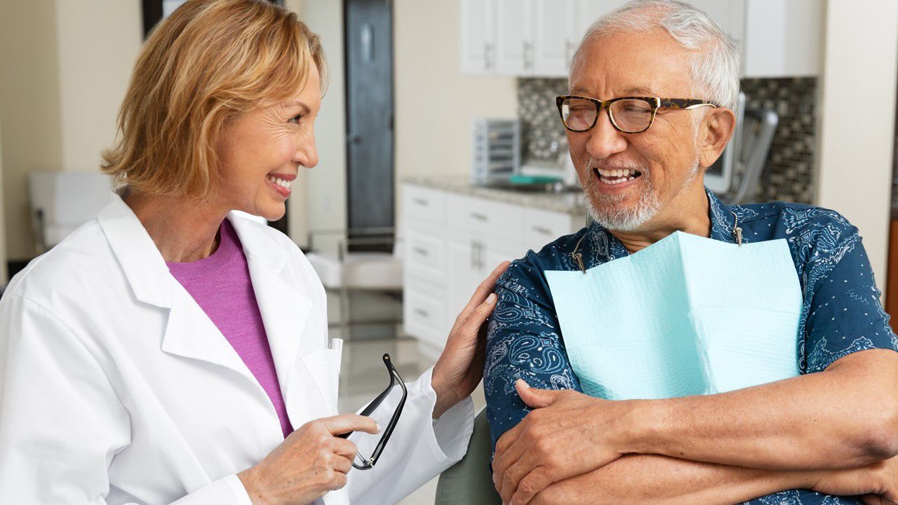 Older man with gray hair at the dental office for an exam